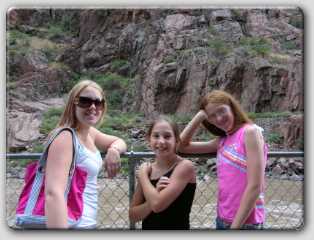 the girls posing in front of the Arkansa river that runs through the bottom of the gorge